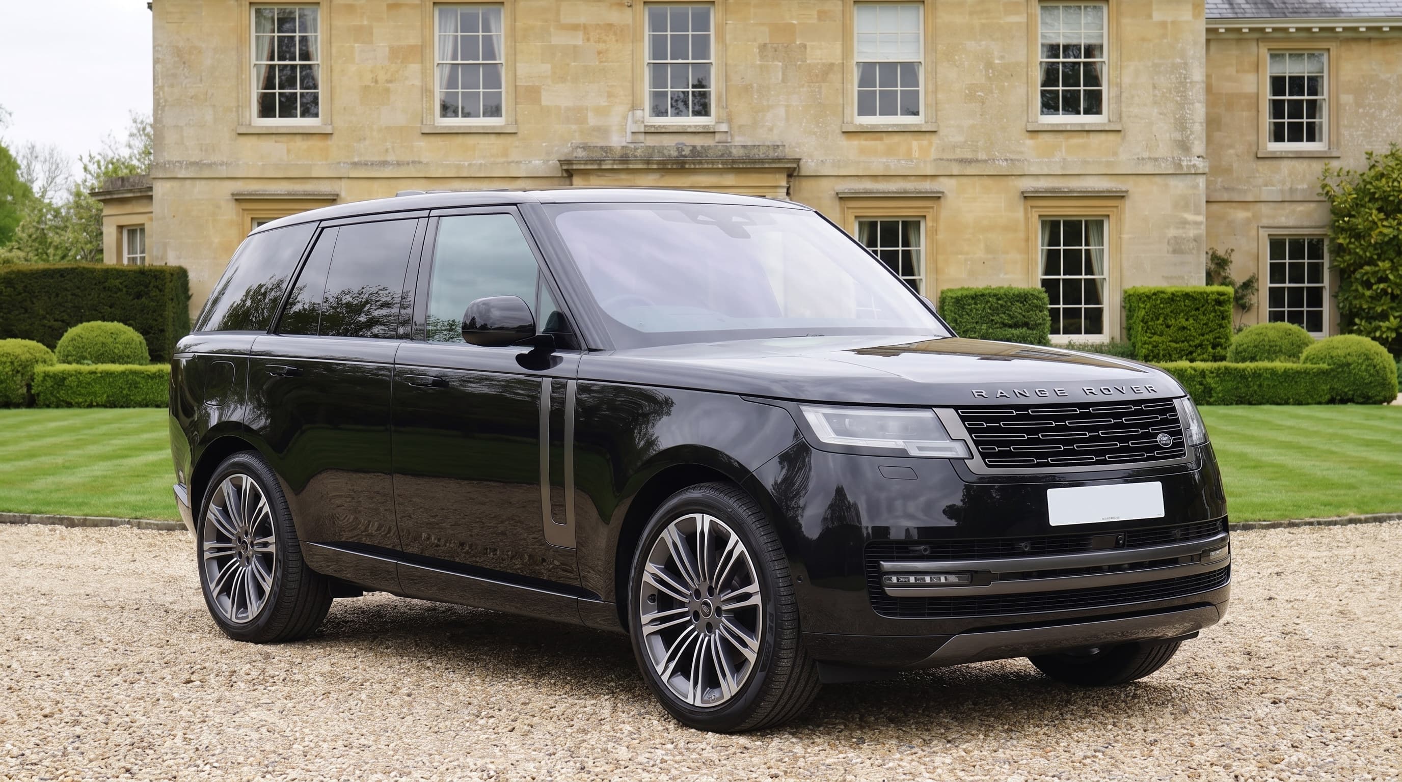 Black Range Rover long wheelbase on the gravel drive of a Surrey country house